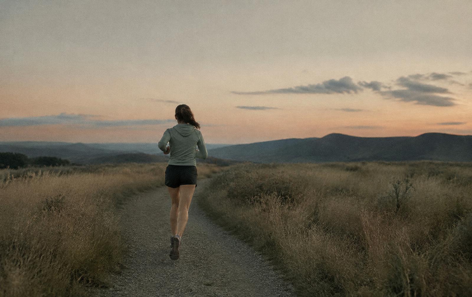 Runner on a gravel trail at dusk